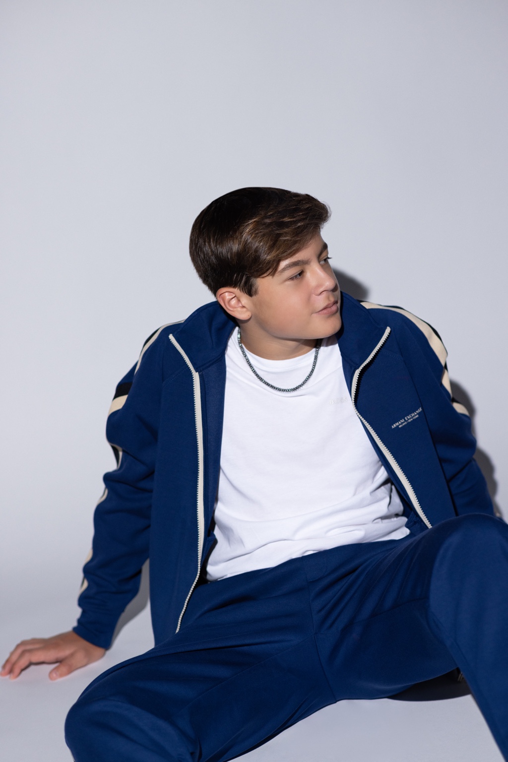 Lucas Knight seated in a navy jacket, looking to the side