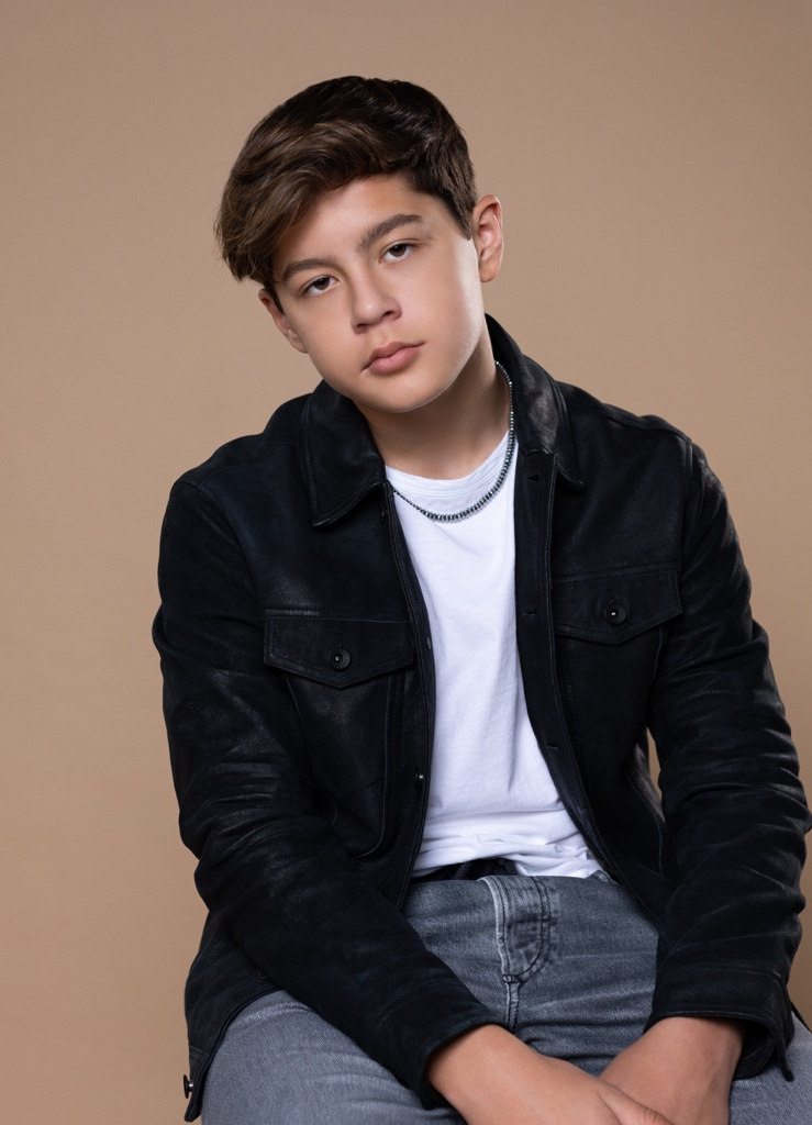 Lucas Knight wearing a black jacket in a studio portrait